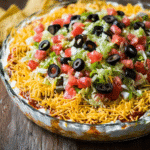 Taco Dip Recipe with classic toppings and tortilla chips