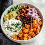Sweet Potato Taco Bowls served with toppings in rustic bowls